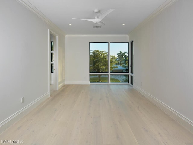 empty room with ceiling fan, ornamental molding, and light hardwood / wood-style floors