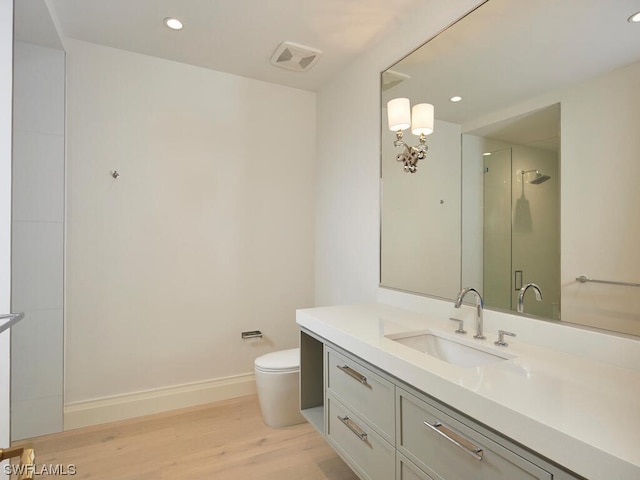 bathroom featuring vanity, hardwood / wood-style floors, and toilet