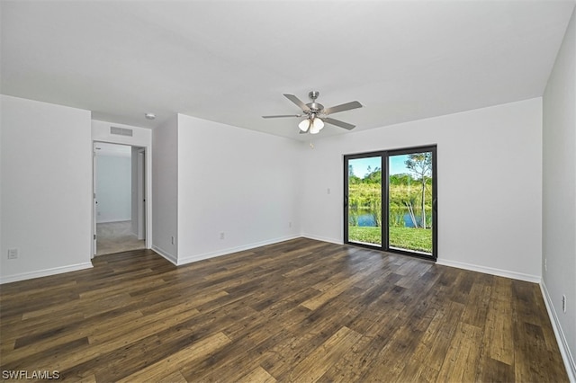 unfurnished room with dark hardwood / wood-style floors and ceiling fan