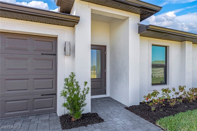 view of exterior entry featuring a garage