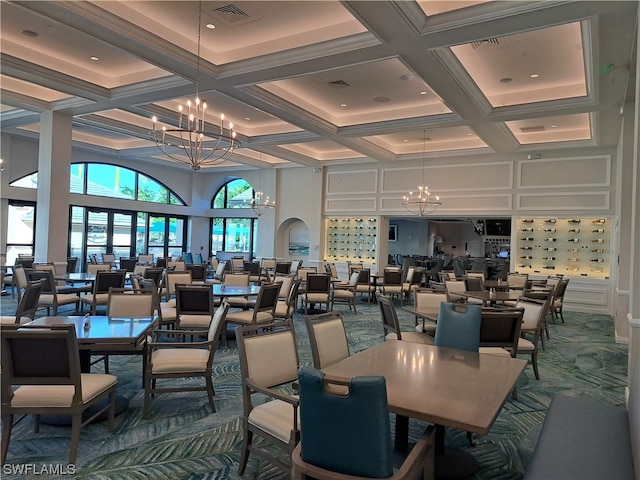 dining area featuring a notable chandelier, beam ceiling, a towering ceiling, and coffered ceiling