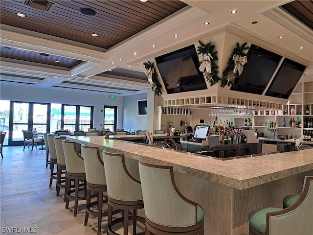 bar with coffered ceiling, crown molding, and light tile flooring