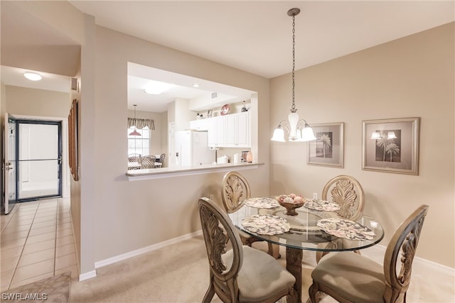 dining room featuring a chandelier and light tile flooring