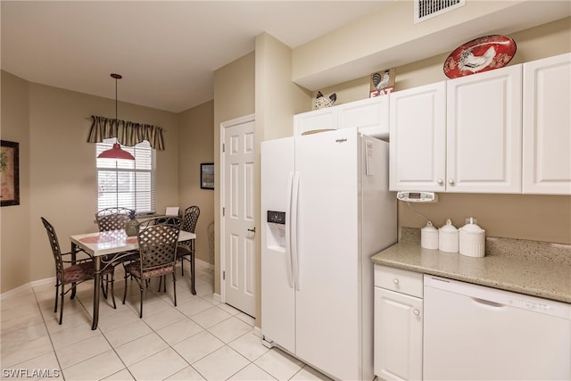 kitchen featuring pendant lighting, light tile flooring, light stone countertops, white appliances, and white cabinets