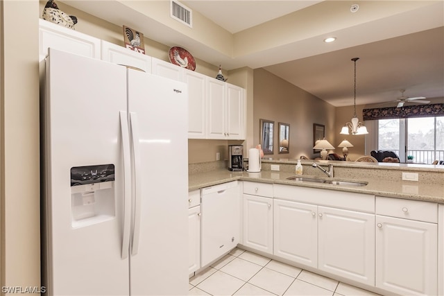 kitchen with white cabinets, light tile floors, white appliances, and ceiling fan with notable chandelier