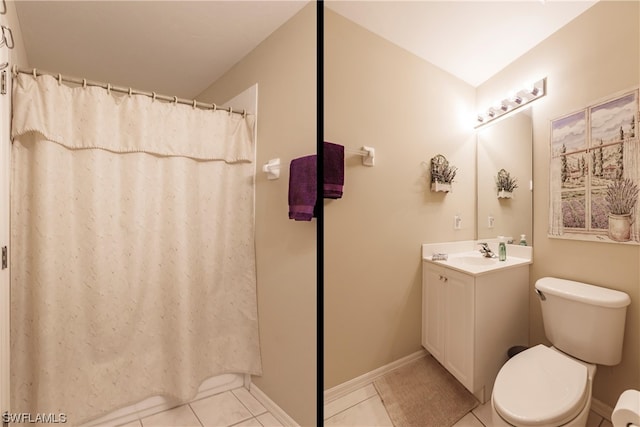 bathroom with tile flooring, large vanity, and toilet