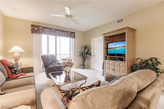 living room featuring carpet floors and ceiling fan