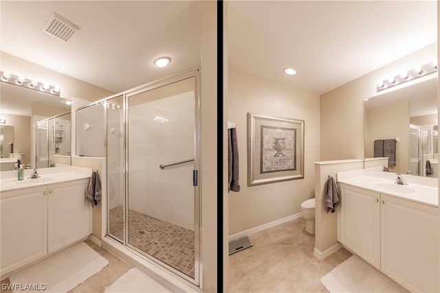 bathroom with tile floors, toilet, vanity, and a shower with shower door