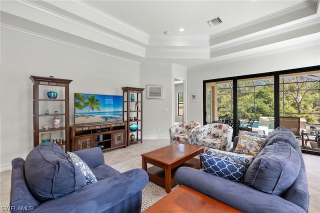 tiled living room with ornamental molding and a tray ceiling