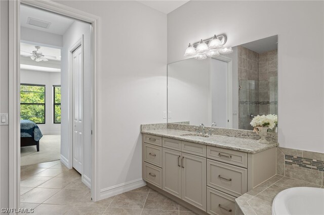 bathroom featuring vanity, tile patterned floors, and shower with separate bathtub