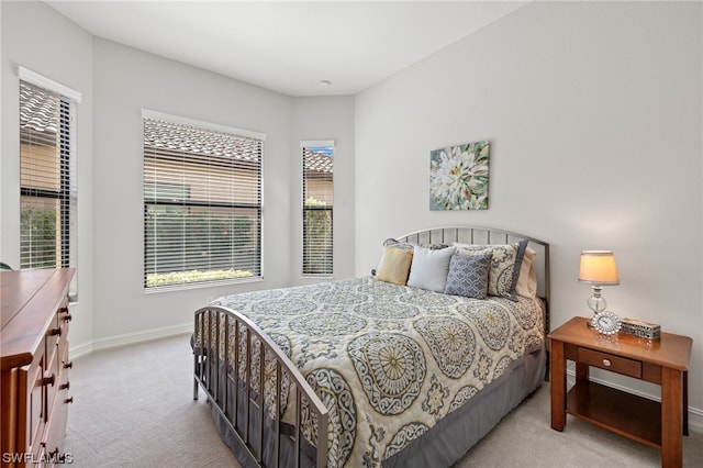 bedroom with light colored carpet