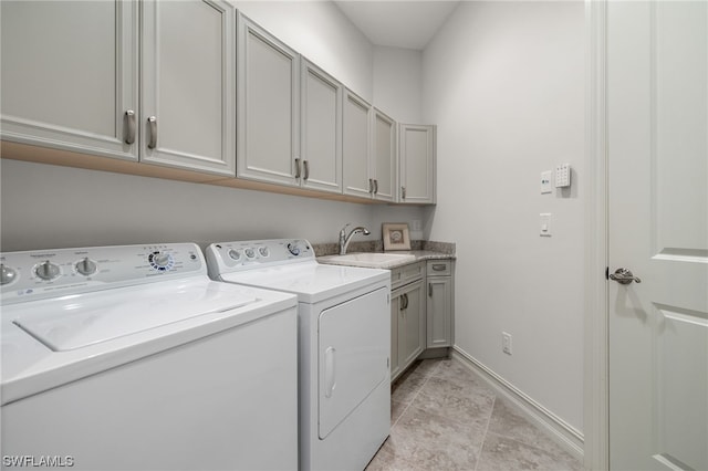 laundry area with sink, cabinets, and washer and dryer