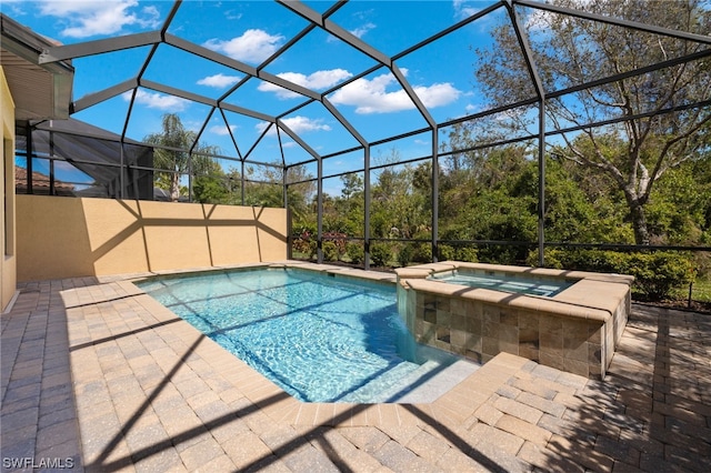 view of swimming pool with an in ground hot tub, a lanai, and a patio