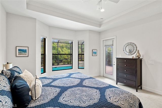 bedroom featuring ceiling fan, access to exterior, ornamental molding, light carpet, and a raised ceiling