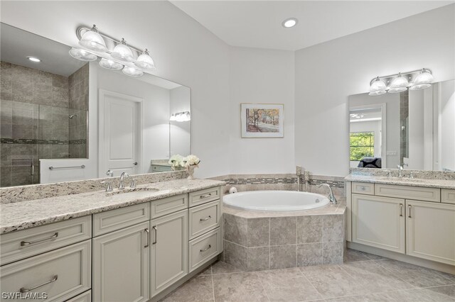 bathroom with vanity, plus walk in shower, and tile patterned flooring