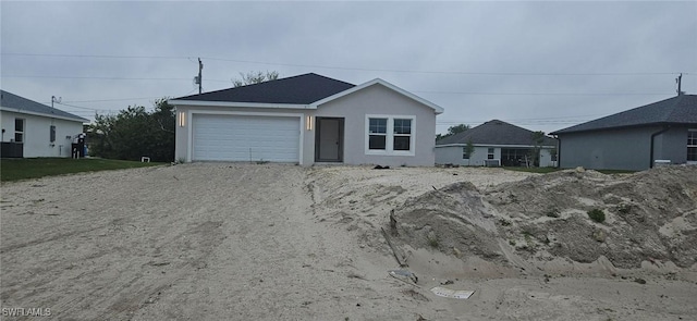 ranch-style house with driveway and stucco siding