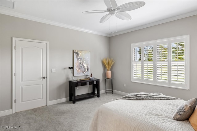 carpeted bedroom featuring crown molding and ceiling fan