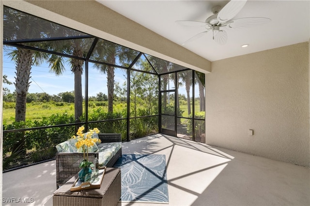 unfurnished sunroom with ceiling fan