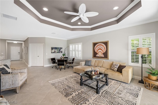 living room with a wealth of natural light, ceiling fan, and ornamental molding