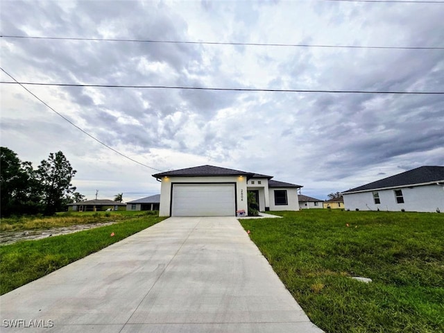 view of front of property with a garage and a front yard