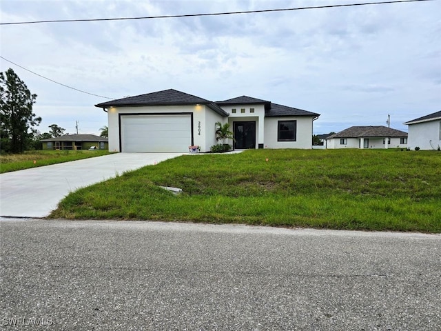 view of front of house with a garage and a front yard