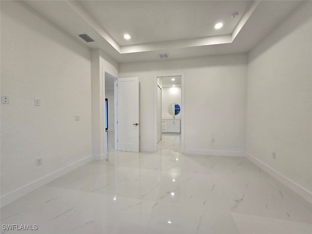 unfurnished room with a tray ceiling