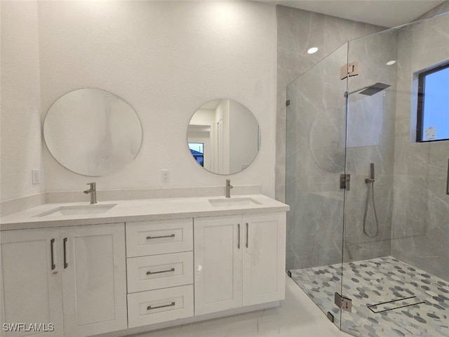 bathroom featuring vanity and a shower with shower door