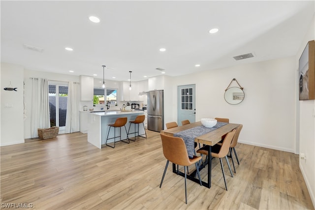 dining area with light hardwood / wood-style floors