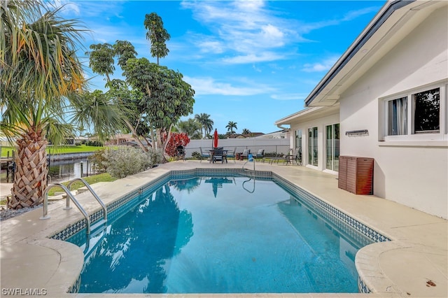 view of swimming pool featuring a patio area