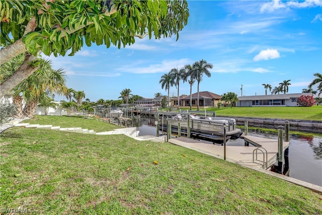 exterior space featuring a lawn, a water view, and a boat dock