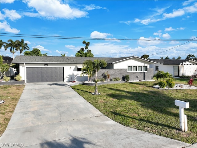 ranch-style house featuring a front lawn and a garage