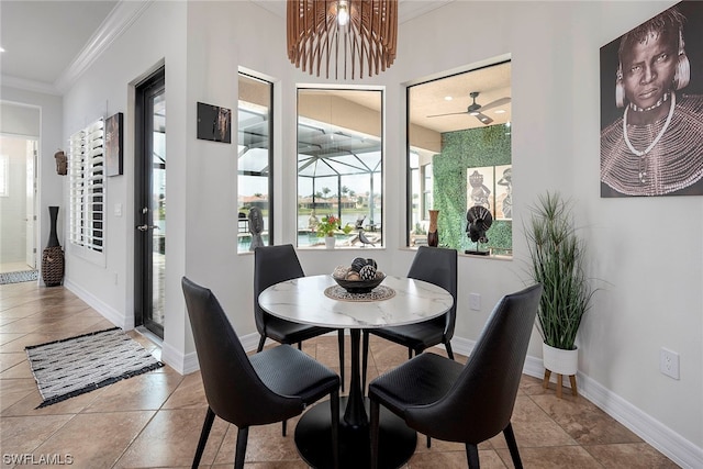 tiled dining area with crown molding and ceiling fan