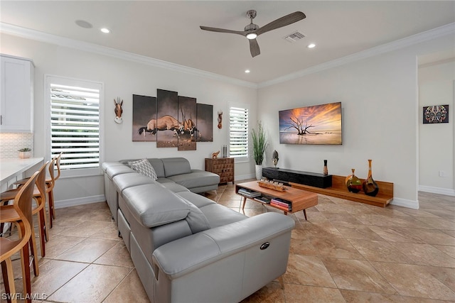 tiled living room featuring ornamental molding and ceiling fan