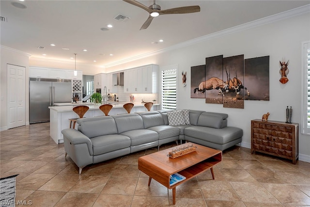 living room with light tile floors, crown molding, and ceiling fan