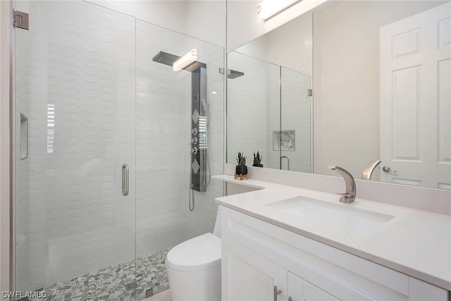 bathroom with oversized vanity, toilet, and a shower with door