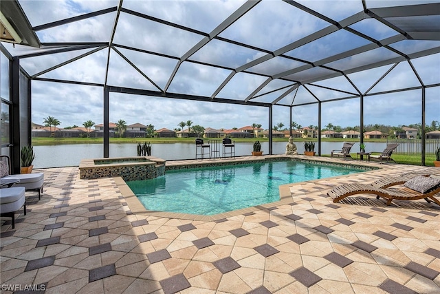 view of swimming pool featuring a patio, an in ground hot tub, and a lanai