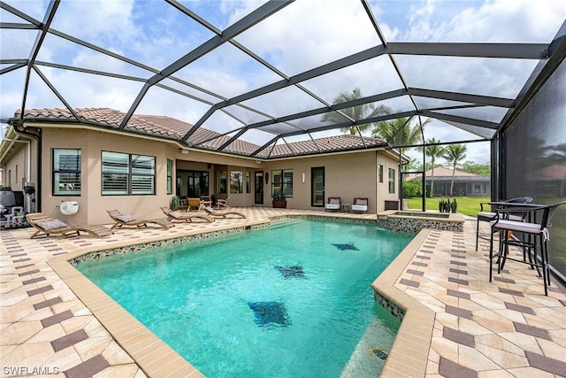 view of pool with a patio and glass enclosure