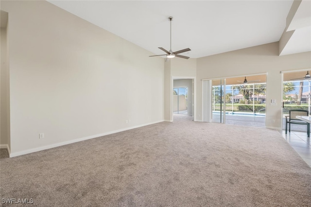 empty room with light carpet, a ceiling fan, and baseboards