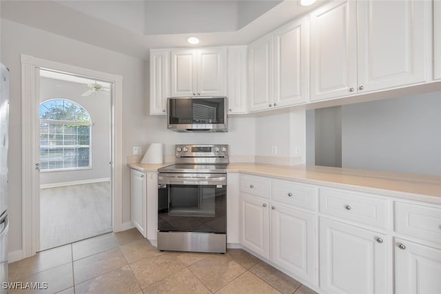 kitchen featuring ceiling fan, stainless steel appliances, light countertops, and white cabinetry