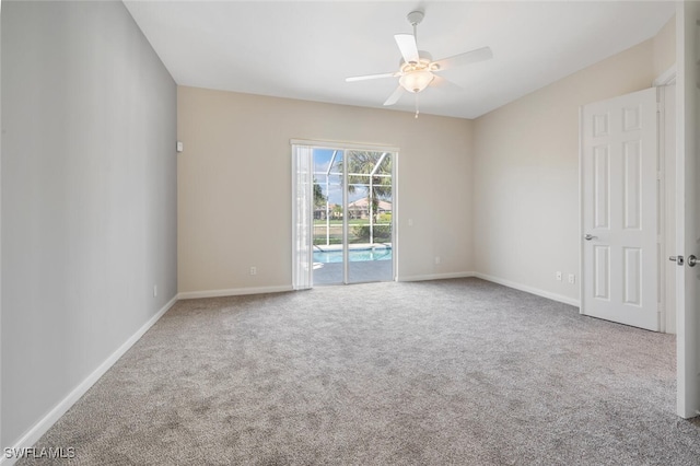 carpeted empty room featuring ceiling fan and baseboards