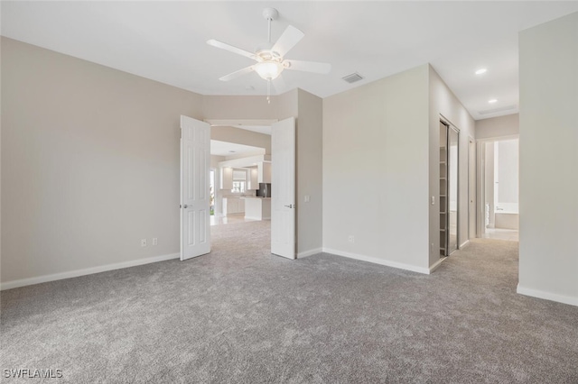 carpeted empty room featuring a ceiling fan, recessed lighting, visible vents, and baseboards