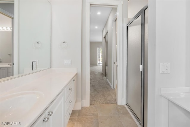 bathroom with a stall shower, recessed lighting, and vanity