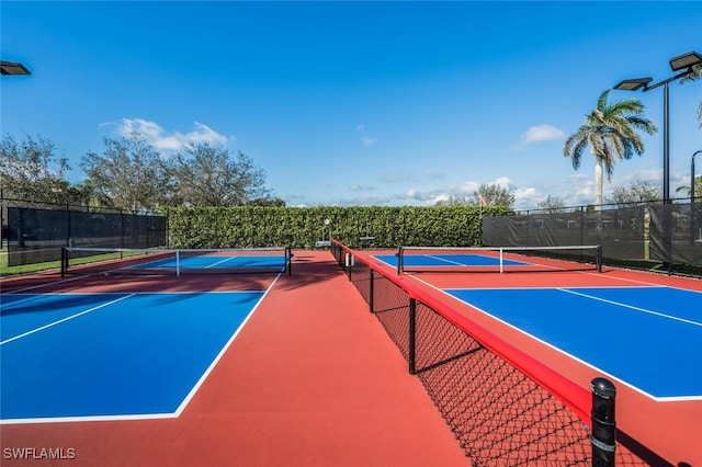 view of sport court featuring fence