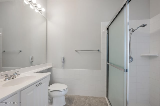 full bathroom with a shower stall, toilet, and vanity