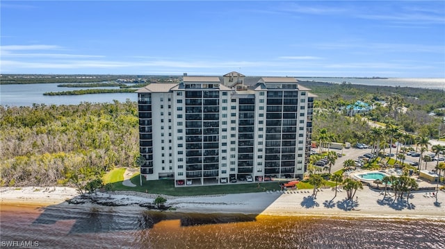 birds eye view of property with a water view and a view of the beach