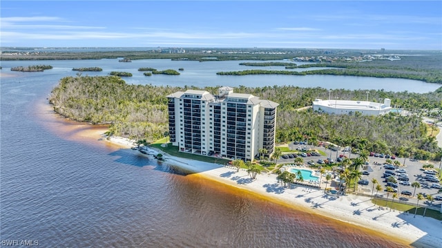 drone / aerial view featuring a beach view and a water view