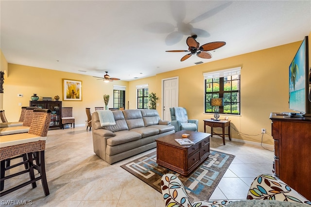 living room featuring light tile flooring and ceiling fan