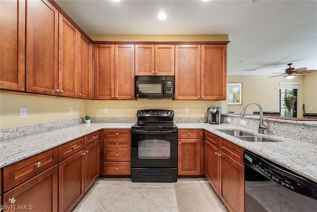 kitchen with light tile flooring, light stone counters, ceiling fan, sink, and black appliances