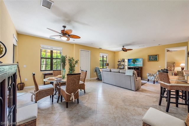 dining space featuring ceiling fan and light tile floors