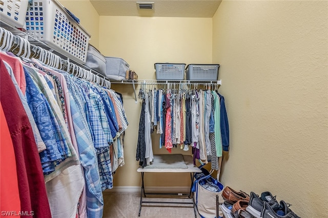 walk in closet featuring carpet floors